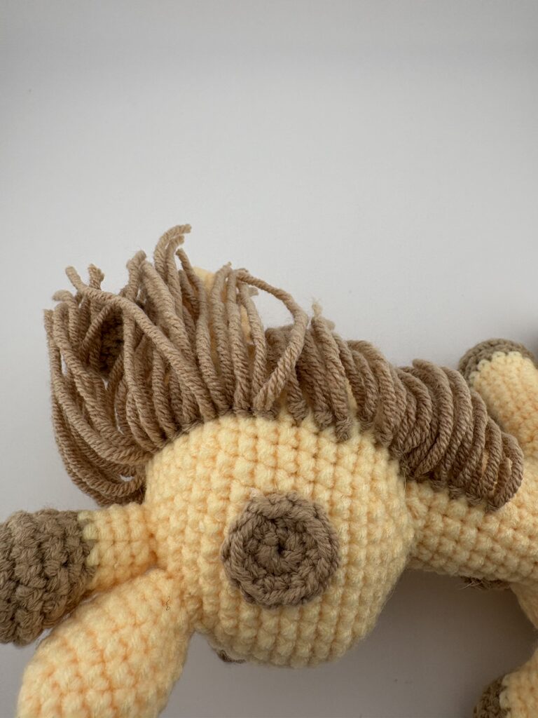 Amigurumi Giraffe mane in light brown yarn.